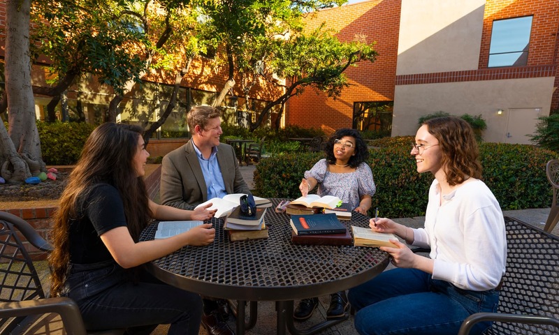image shows Van Hook speaking with students