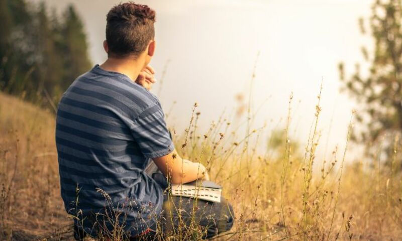 Man with Bible looking thoughtfully into the distance