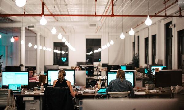 Corporate office building with employees seated at computers