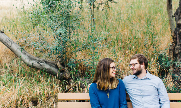 a man and a woman sitting on a bench