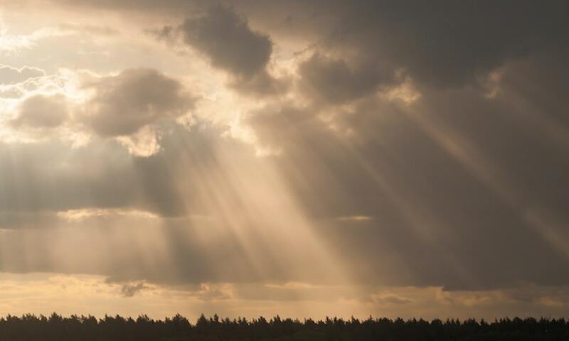 Image shows sun rays breaking through clouds