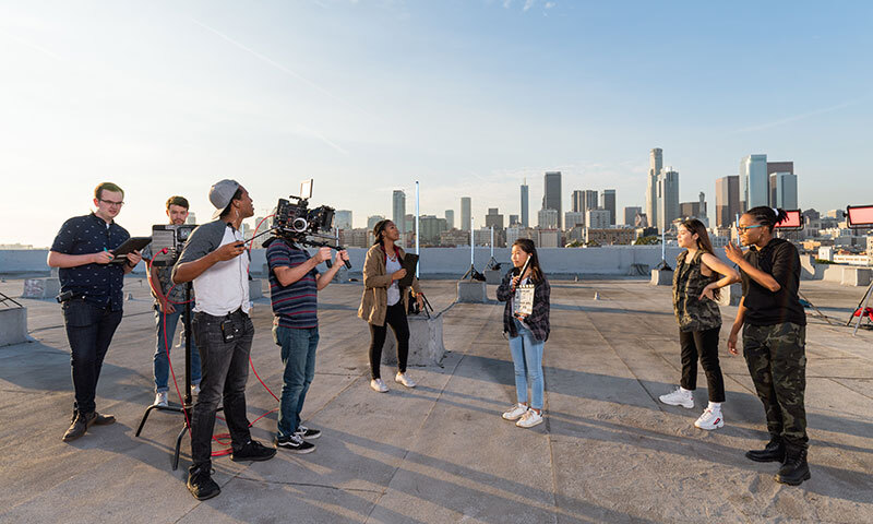 Biola students on set at a film shoot on rooftop overlooking downtown LA