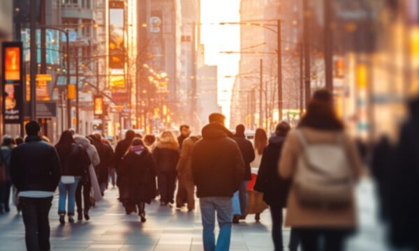 image shows people walking in a city
