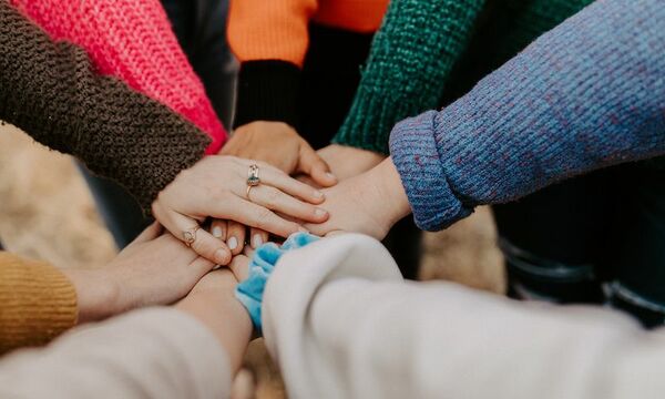 Hands connecting in the center