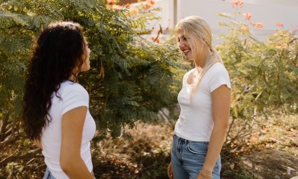 Two college-aged girls talking