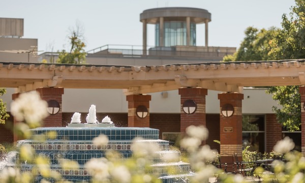 Image shows the Fluor Fountain of Faith with the Library Beacon in the background 