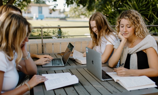 Four college-aged girls studying together