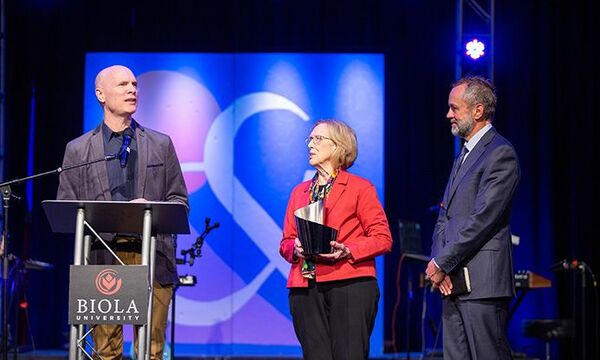 Luis Palau accepting award on stage
