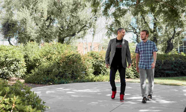 A student and professor walk together at Biola University