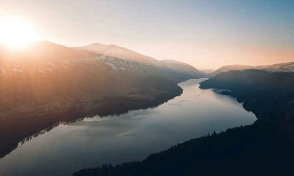 image shows a river with the sun low