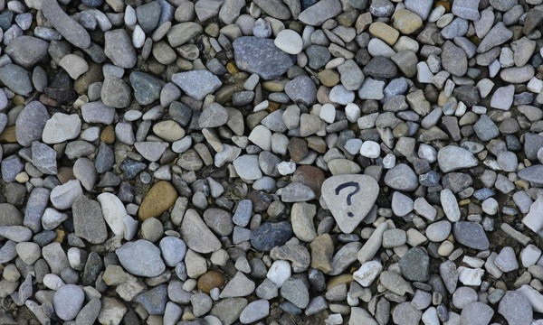 image shows rocks with a question mark on one of them