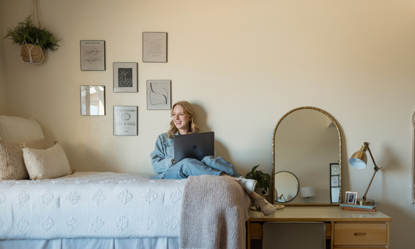 Student studying on a bed