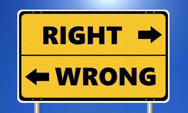 A road sign pointing toward 'right' or 'wrong'