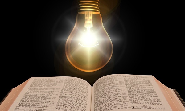 image shows light over Bible