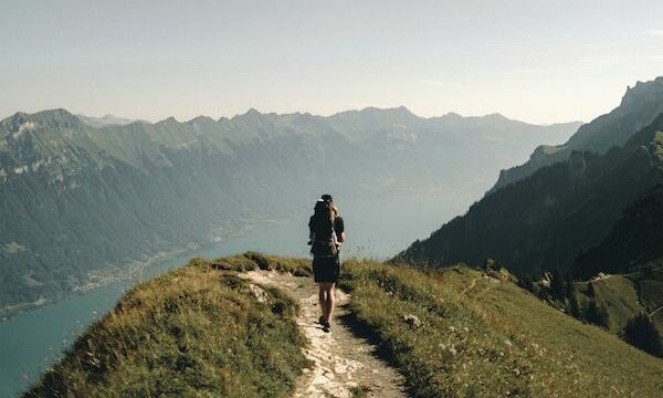 Image shows a person walking on a trail 