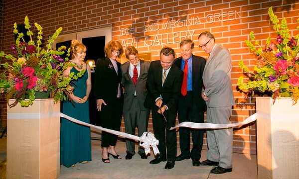 People cutting a ribbon