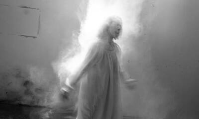 Black and white photo of a human with smoke around