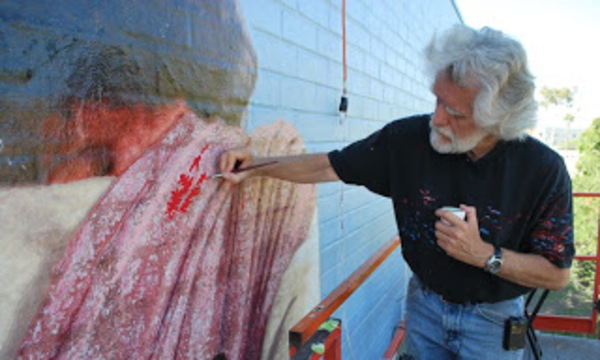 man restoring a mural