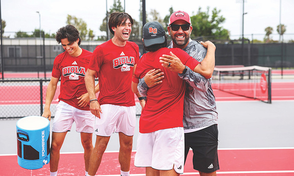 Biola men's tennis team embracing after a match