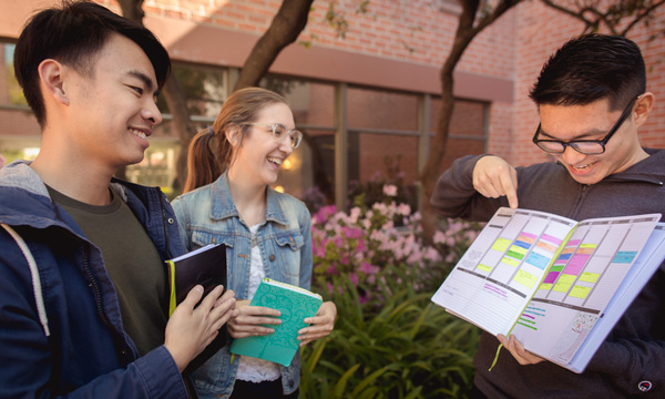 Three students with a planner