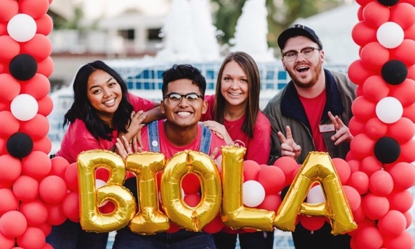 group of students in front of balloon frame