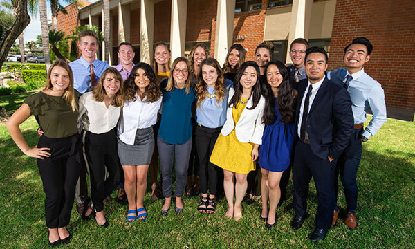 a group of smiling young men and women
