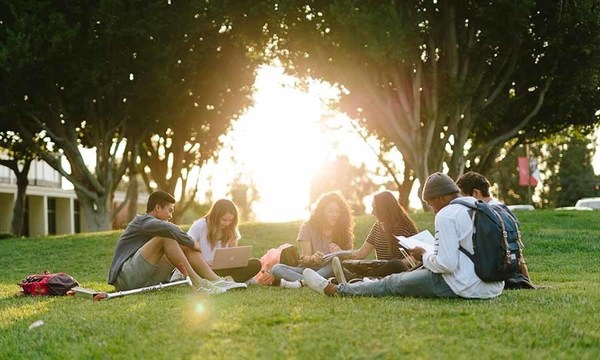 Biola students studying on a lawn