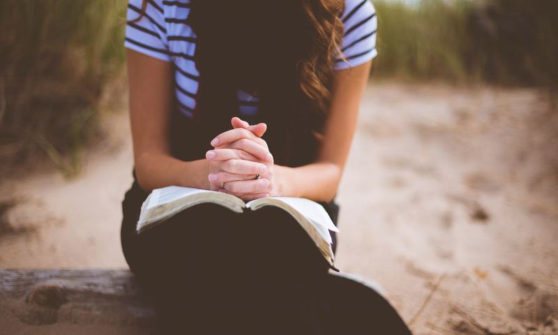 Woman sitting with Bible in her lap