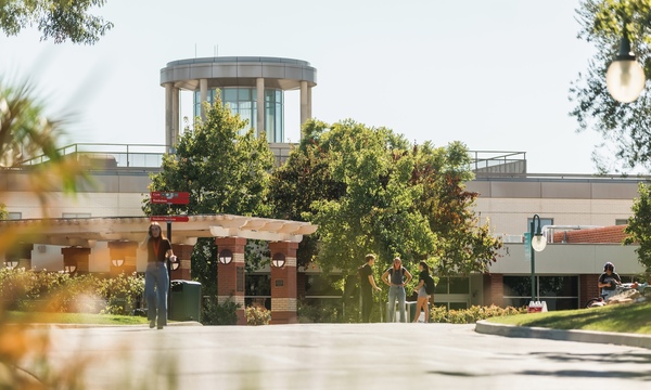 image shows students walking on campus