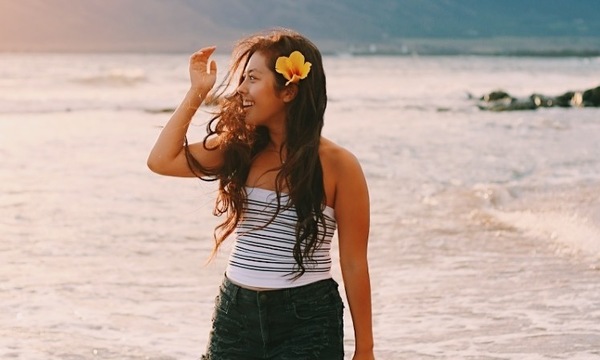young woman sanding on a beach