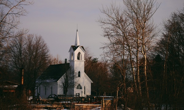 A small church surrounded by trees