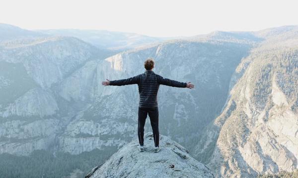 man on top of cliff