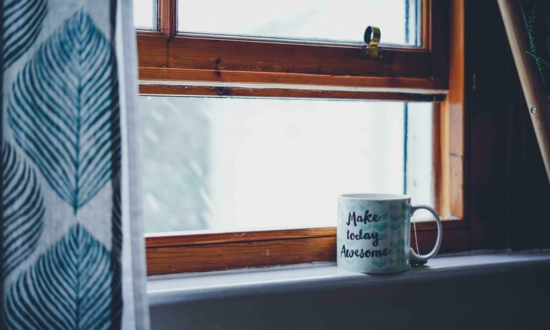 Coffee cup under a window sill