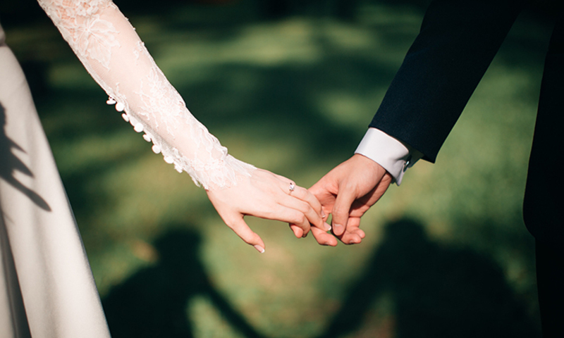 Bride and groom holding hands