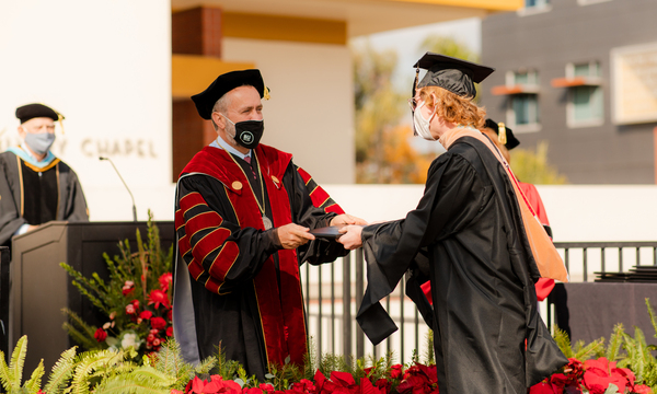 President Corey and Student at graduation