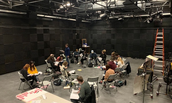 A group of students sitting in a circle in a film studio