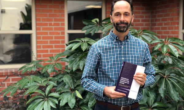Joe Henderson holding a book