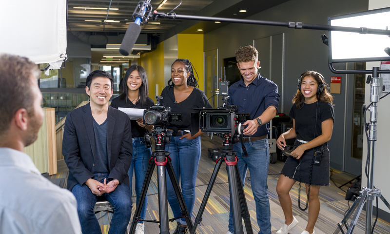 A group of students operating film equipment