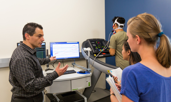 Students monitoring person on a treadmill