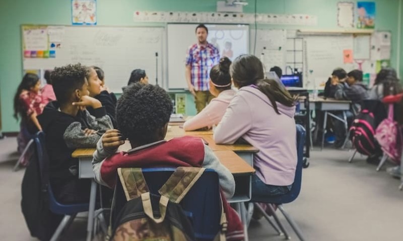 Student teacher in classroom full of students