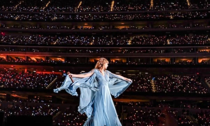 taylor swift at the eras tour in a blue dress