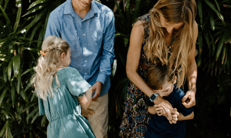 Mom and Dad playing with two children - one boy and one girl