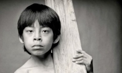 Child holding a wooden beam