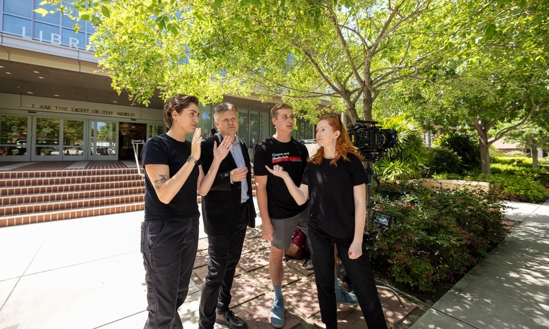 Image shows Tom Halleen with film students 