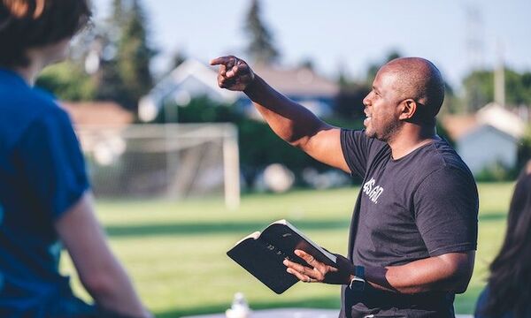 Man pointing in field