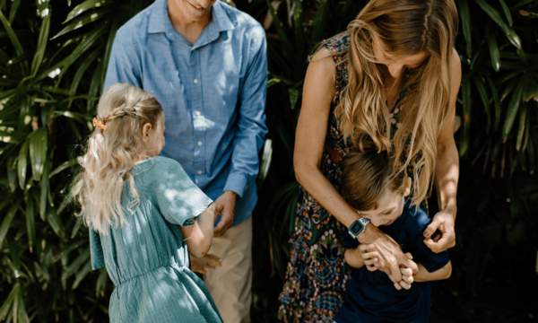 Mom and Dad playing with two children - one boy and one girl
