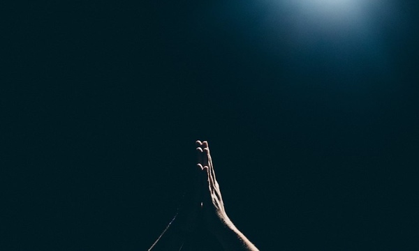 image shows praying hands 