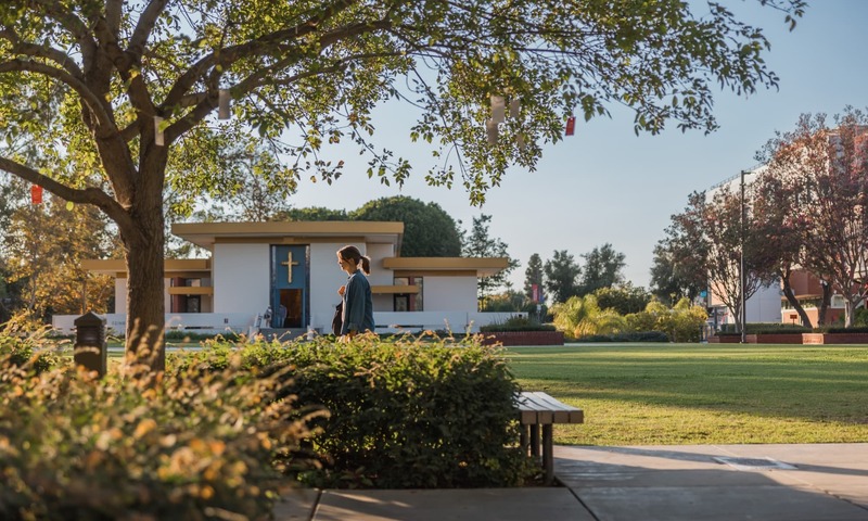 Image shows a student walking in front of Calvary Chapel