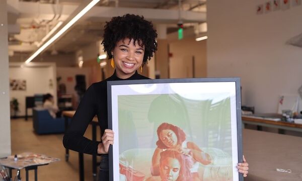 Eden holding her artwork