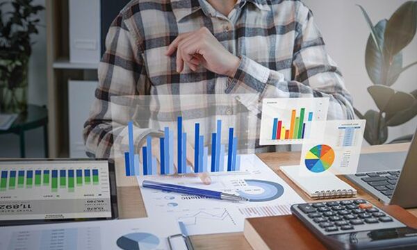 accountant on desk with visible graphs